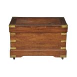 A late 19th / early 20th century mahogany and brass trunk the hinged lid opening to storage,