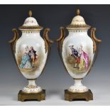 A pair of Sevres style porcelain urn shaped lidded vases