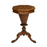 A Victorian mahogany octagonal sewing table with a central octagonal compartment surrounded by