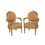 A fine pair of antique French carved and gilded spoon-back fauteuils the backs with ribbon-twist and
