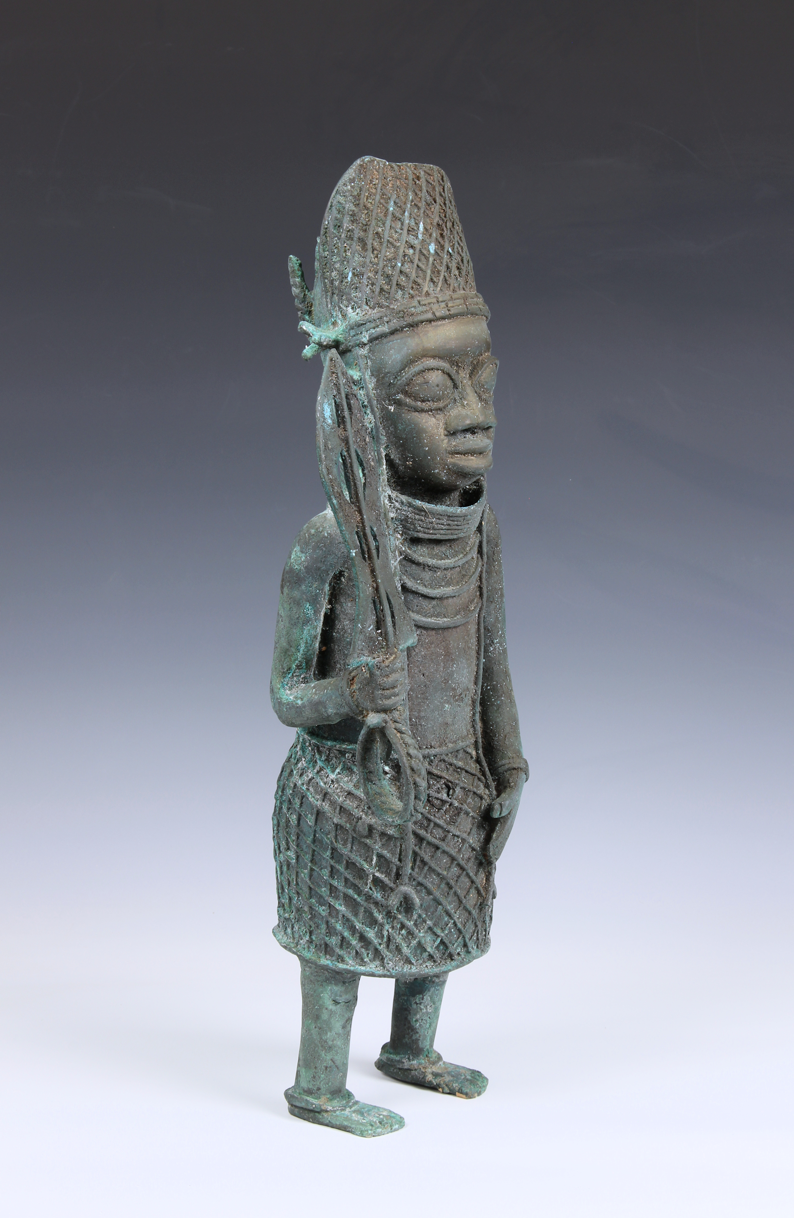 A large Benin style Nigerian bronze figure of an warrior 20th century, standing holding a sword with - Image 2 of 4