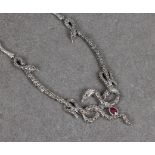 A silver ruby and marcasite serpent necklace, with three intertwining snakes, rubies for eyes, and a