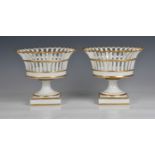 A pair of French porcelain comports of pedestal basket form