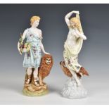 A pair of Rudolstadt porcelain figures in floral dress