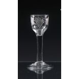 A mid-18th century engraved wine glass c.1745, the ogee bowl engraved with a fruiting vine and a