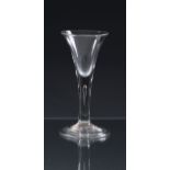 A mid-18th century plain stemmed wine glass c.1750, the drawn trumpet bowl on a teared stem and