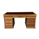A Victorian pedestal desk with gilt tooled inset red leather top over three frieze drawers and two