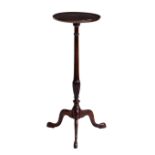 A George III style mahogany lamp table 1920s-30s, the dished, circular top on a turned and reeded
