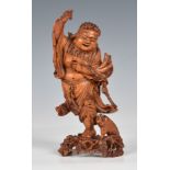 A finely carved Chinese boxwood figure of Liu Hai probably 19th century, the rotund figure in an