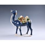 A Chinese sancai glazed, Tang Dynasty style figure of a caparisoned camel 20th century, the camel in