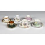 A collection of six various porcelain coffee and tea cups with saucers