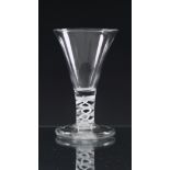 A mid-18th century opaque twist firing glass c.1760, the drawn trumpet bowl on a double-series
