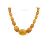 A single strand graduated amber bead necklace mid-20th century, comprising forty six oval amber