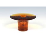 An amber glass, heavy, disc-topped vase with solid cylinder base by Nanny Still