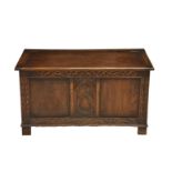 A carved mahogany chest 1930's, the hinged top over a two panel front with carved top rail and