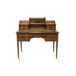An Edwardian inlaid rosewood ladies writing desk with a tooled leather top, a galleried back with