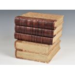 A novelty ice bucket in the form of a stack of antiquarian books the marble papered books with