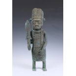 A large Benin style Nigerian bronze figure of an warrior 20th century, standing holding a sword with
