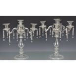 A pair of Christian Dior clear glass three branch, four light candelabra