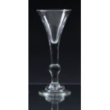An early 18th century 'kit kat' balustroid wine glass c.1730, the drawn trumpet bowl on a plain stem