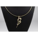 A 9ct gold and diamond B Love Letter pendant necklace by Catherine Best on a 9ct gold Omega chain,