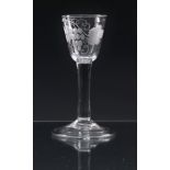 A mid-18th century engraved wine glass c.1745, the round funnel bowl engraved with a fruiting vine
