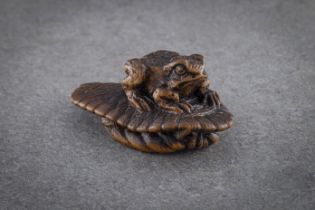 A WOOD NETSUKE OF A TOAD ON SANDAL