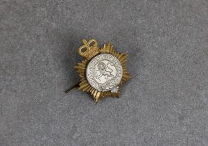 A Royal Alderney Militia cap badge.