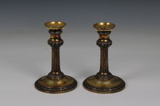 A rare pair of George II silver gilt candlesticks