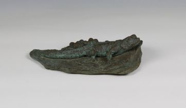 A patinated bronze sculpture of a lizard