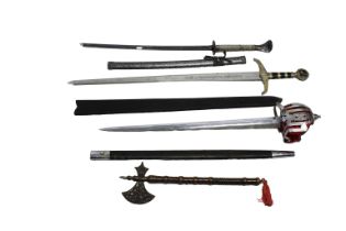Three modern replica swords together with a modern ornamental axe