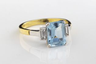 An 18ct yellow and white gold aquamarine and diamond three-stone ring