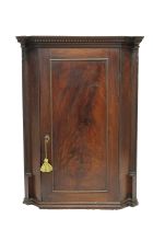 A Georgian mahogany corner cupboard