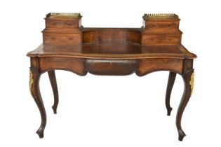 A Louis XVI style serpentine rosewood bureau plat