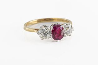 An 18ct yellow gold ruby and diamond three stone ring
