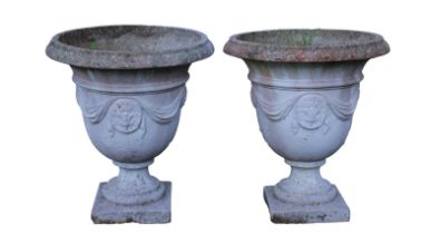 Two composite stone urns
