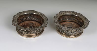 A matched pair of late Georgian silver wine coasters