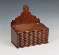 A Georgian mahogany candle box with a decorative carved woven effect front