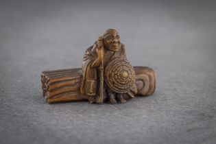 A WOOD NETSUKE OF SOTOBA KOMACHI (depicted as an old hag)