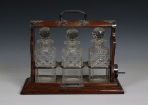 An early 20th Century Three-Bottle Oak Tantalus by Walker and Hall of Sheffield