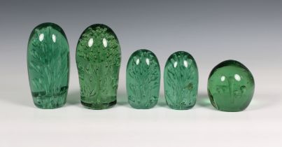 Five graduated Victorian hand blown green glass dump weights