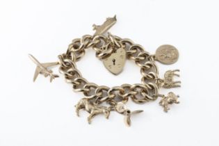 A heavy 9ct yellow gold curb link charm bracelet