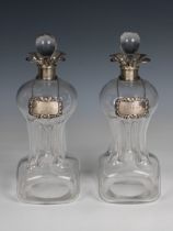 A pair of Edwardian silver mounted Glug-Glug decanters