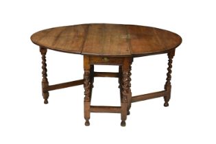 A 17th century and later English oak gate leg oval table