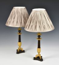 A pair of French patinated bronze and ormolu candlesticks second half of 19th century,