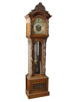 An English, late 19th century, elaborately carved oak musical three train long case clock