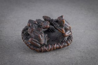 WELL DETAILED AND UNUSUAL WOOD NETSUKE OF THREE TOADS ON A LOTUS LEAF