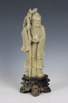 A finely carved celadon soapstone Chinese figure