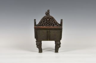 A Chinese patinated bronze and hardwood covered censer