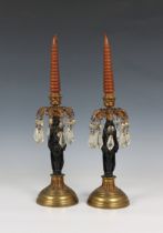 A pair of figural cast iron and gilt metal Egyptian Revival lustre candlesticks